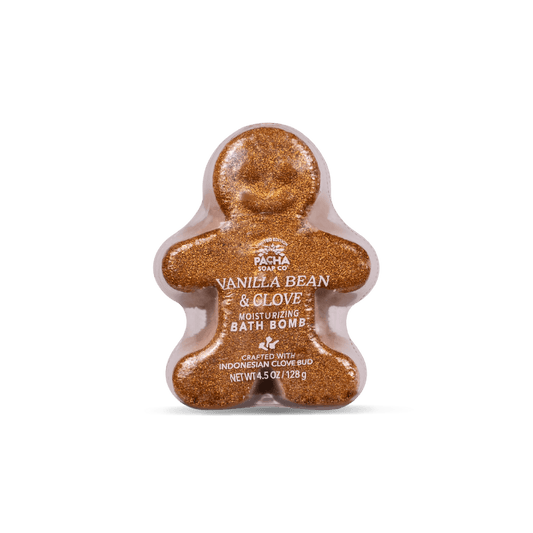 A gingerbread man-shaped bath bomb by Pacha Soap with a sparkling golden-brown glittery texture, centered on a clean white background.