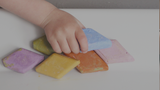 Child holding Bath Crayons