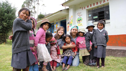 Group photo of adults and children smiling