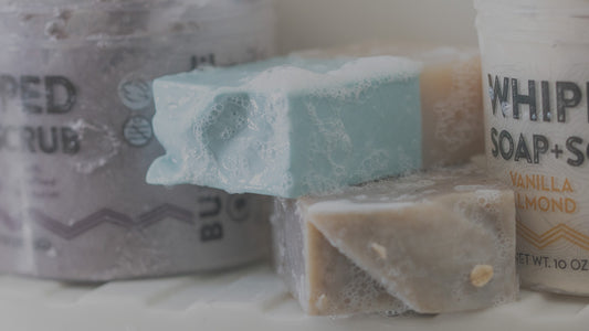 Image of Pacha Soap Whipped Soap + Scrub and bar soap sitting on bath tub