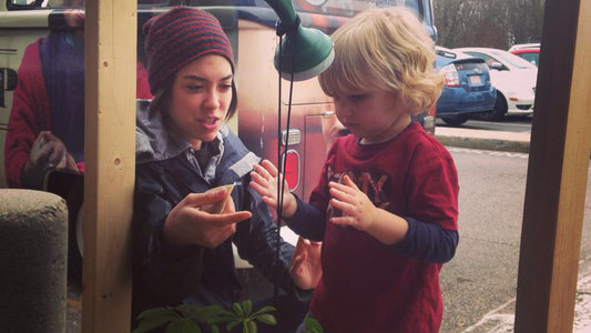 Image of woman and child getting water from faucet 
