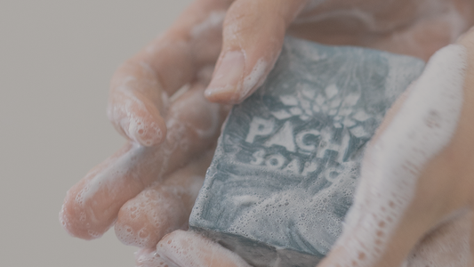 Image of soapy hands holding Pacha Soap bar soap