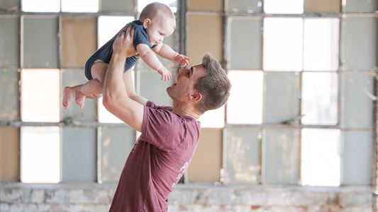Image of Man playing with a baby