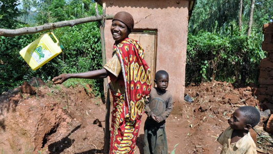 Image of woman and child in front of toilet facility