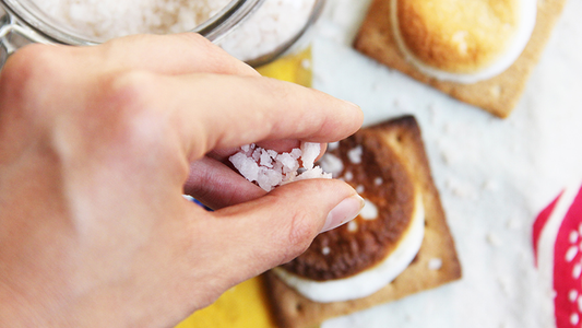 Image of woman adding Peruvian Pink Salt to S'more