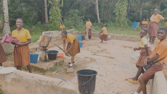 Image of group of people getting water from well