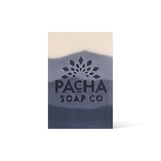 A 4 Tiered bar soap, ranging from cream and gradients down to a dark blue. The Pacha Soap Co. Logo is placed in the middle.
