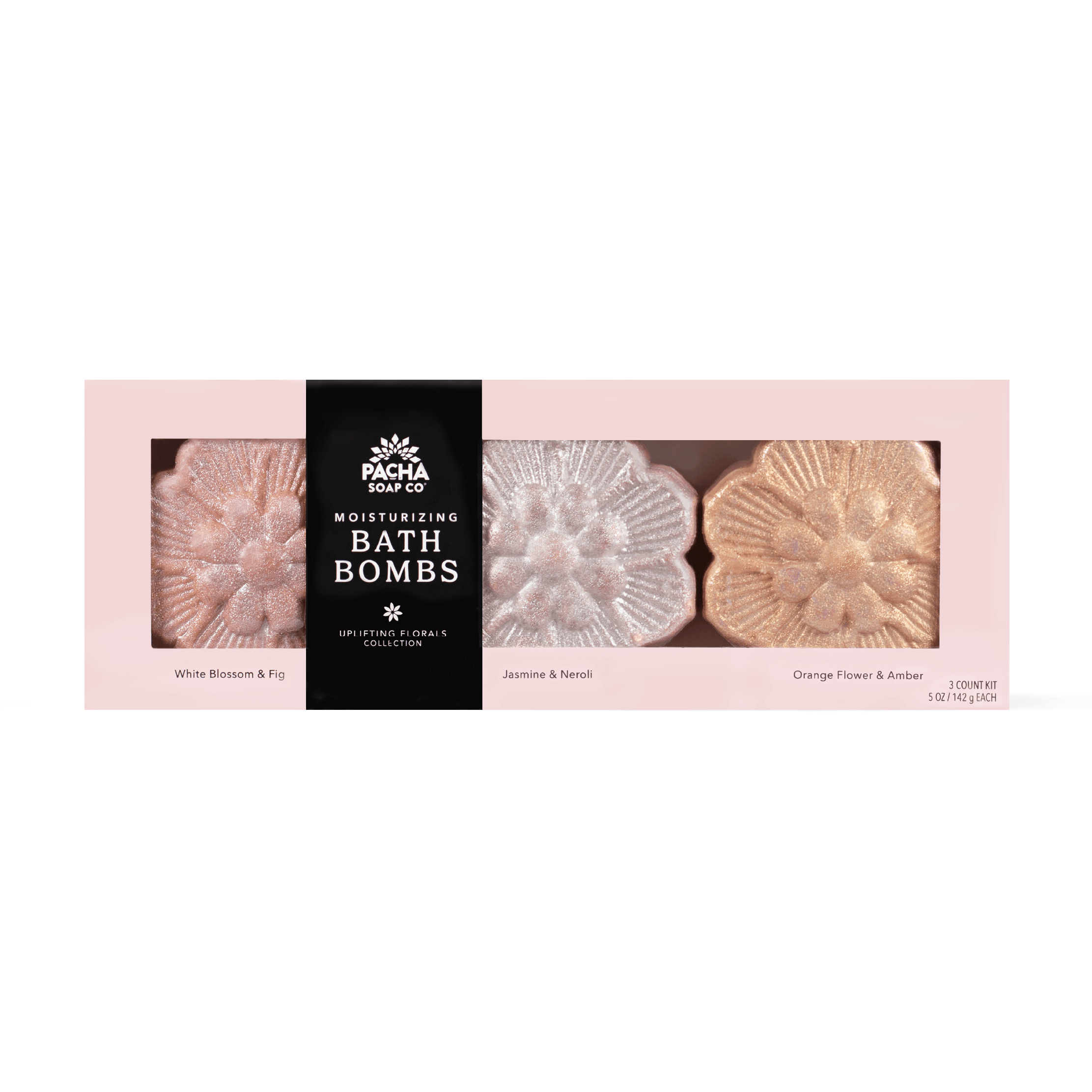 Pacha Soap Co Moisturizing Bath Bombs collection in a pink box with three flower-shaped bath bombs visible through clear windows. The center package is black with white text reading 'PACHA SOAP CO MOISTURIZING BATH BOMBS' and the side packages are pale pink with labels for White Blossom & Fig, Jasmine & Neroli, and Orange Flower & Amber.