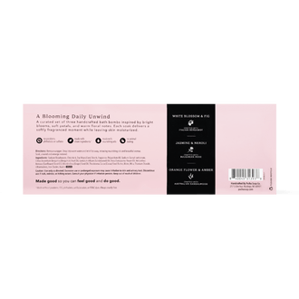The back of a bath bomb package showing product details, ingredients, and a barcode. The design features a soft pink background with a black vertical column on the right containing white text for 'White Blossom & Fig', 'Jasmine & Neroli', and 'Orange Flower & Amber'.