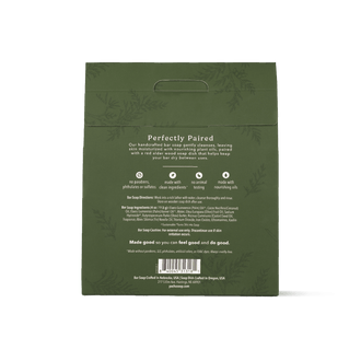 The back of Pacha Soap's Balsam & Pine Bar Soap Dish set, in a dark olive green packaging bag for 'Perfectly Paired' skin moisturizer, featuring product details, ingredients, and a barcode on a white background.