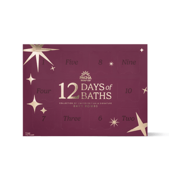 A rectangular bath bomb advent calendar box by Pacha Soap Co. in a deep burgundy color with gold star illustrations and numbered compartments from one to twelve.