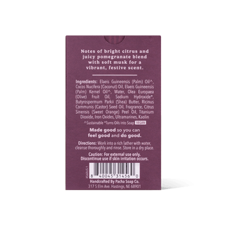 The back of a Pacha Soap Co. Bar soap, showing the scent notes of bright citrus and juicy pomegranate blend, ingredients, directions, barcode, and address