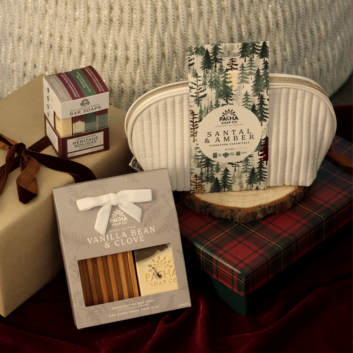 Pacha Soap's Holiday Heritage Bar Soap Set, Santal & Amber Gift Bag Set and Vanilla Bean & Clove Bar Soap & Dish Set in a holiday gift pile