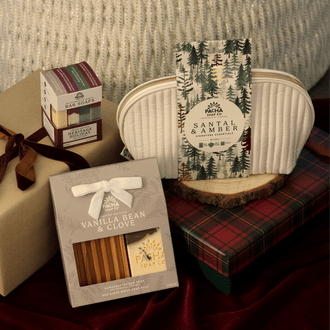 Pacha Soap's Holiday Heritage Bar Soap Set, Santal & Amber Gift Bag Set and Vanilla Bean & Clove Bar Soap & Dish Set in a holiday gift pile