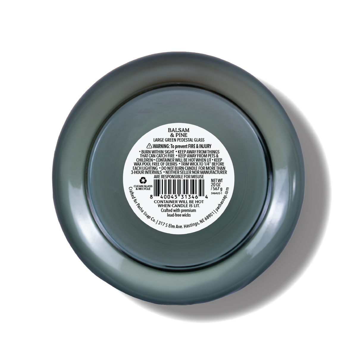 Top-down view of a glass candle with a dark green-gray translucent finish and a white product label in the center
