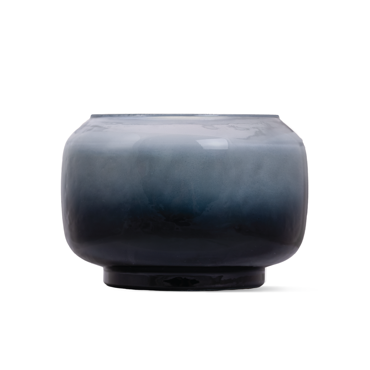 A round glass candle with a smooth gradient finish transitioning from light blue at the top to deep navy blue at the base
