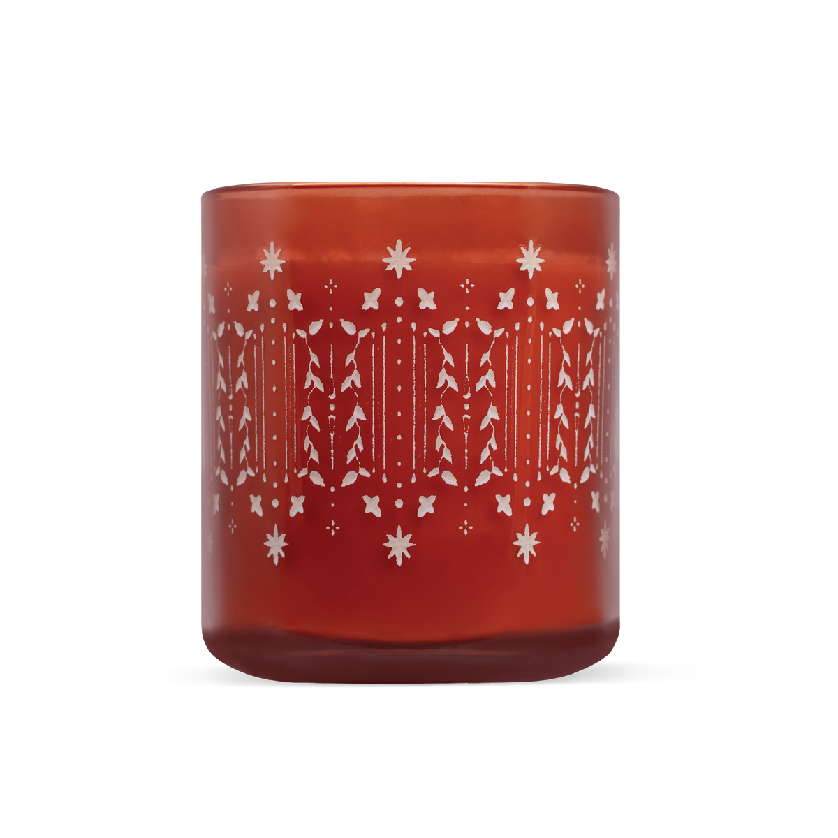 A translucent amber-red glass candle jar with a white etched holiday pattern of, snowflakes and holly leaves