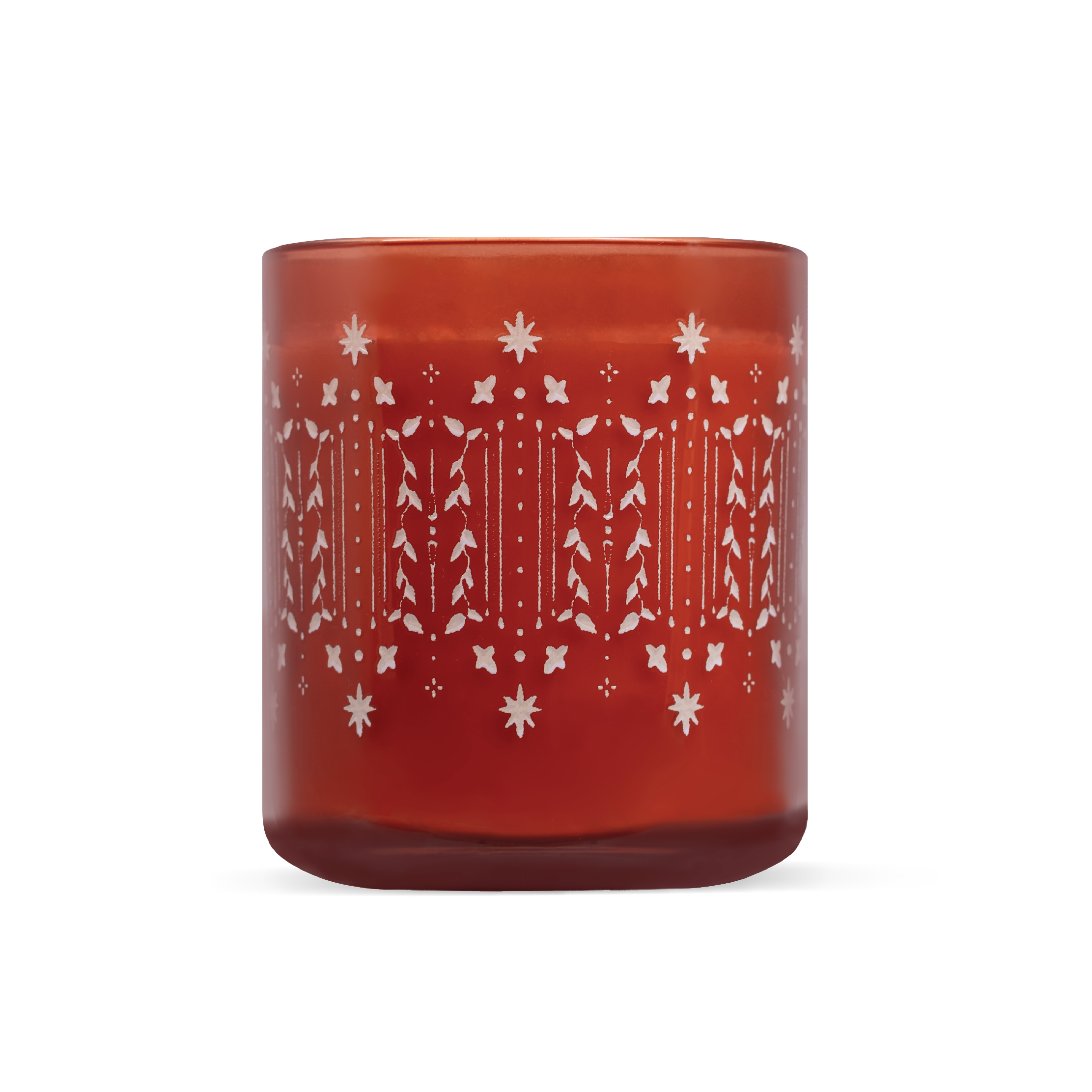 A translucent amber-red glass candle jar with a white etched holiday pattern of, snowflakes and holly leaves