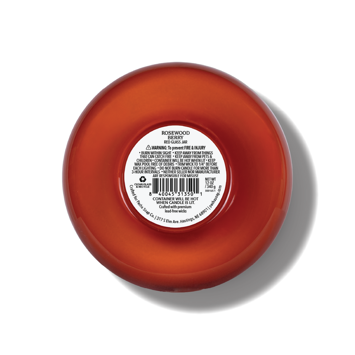 The bottom of a rosewood scented candle, showing a white product information label