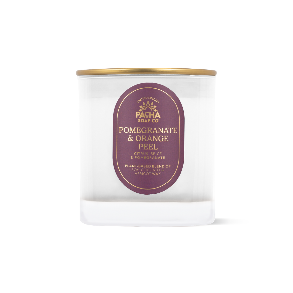 A clear glass jar candle with a gold metal lid and a dark purple oval label reading 'PACHA SOAP CO POMEGRANATE & ORANGE PEEL'.