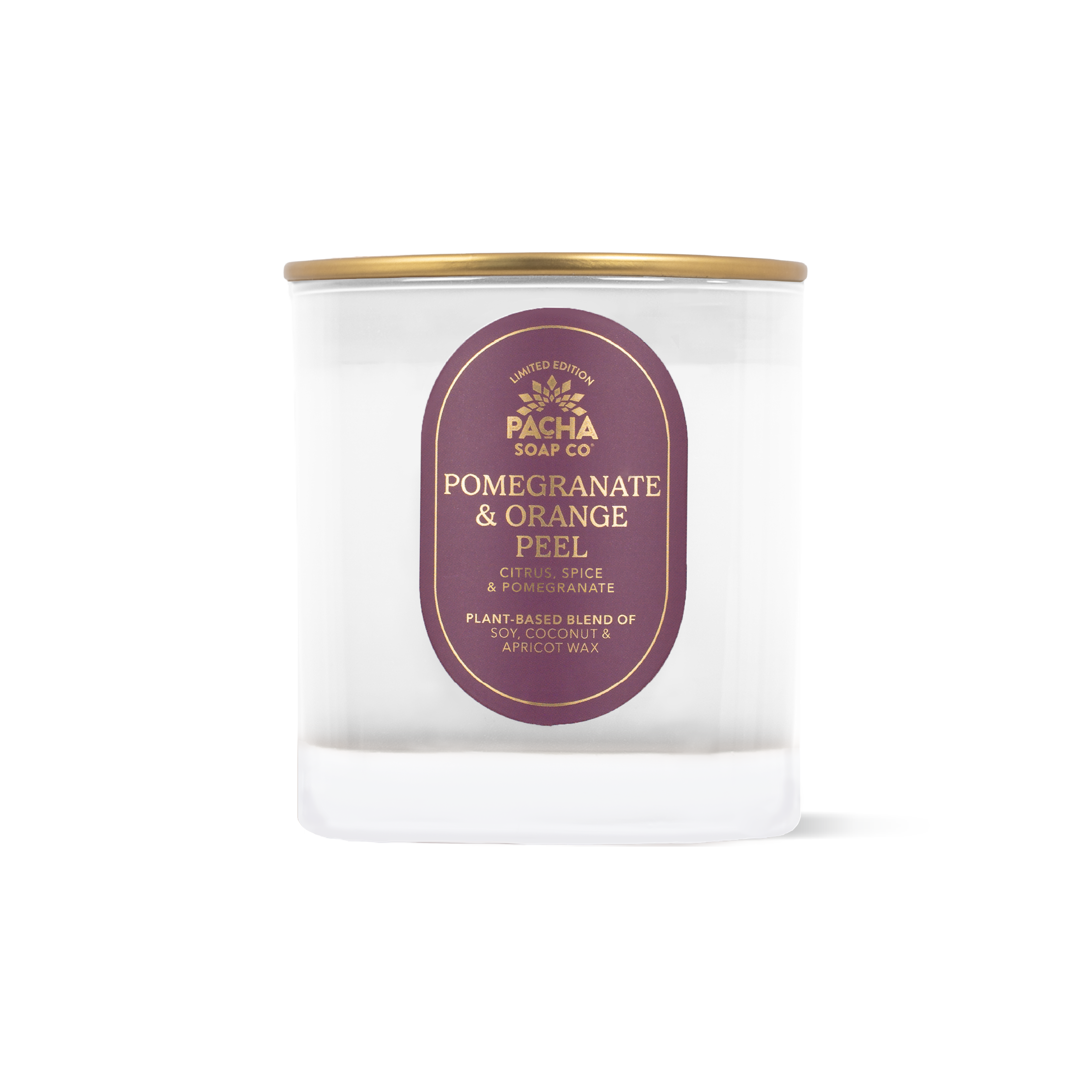 A clear glass jar candle with a gold metal lid and a dark purple oval label reading 'PACHA SOAP CO POMEGRANATE & ORANGE PEEL'.