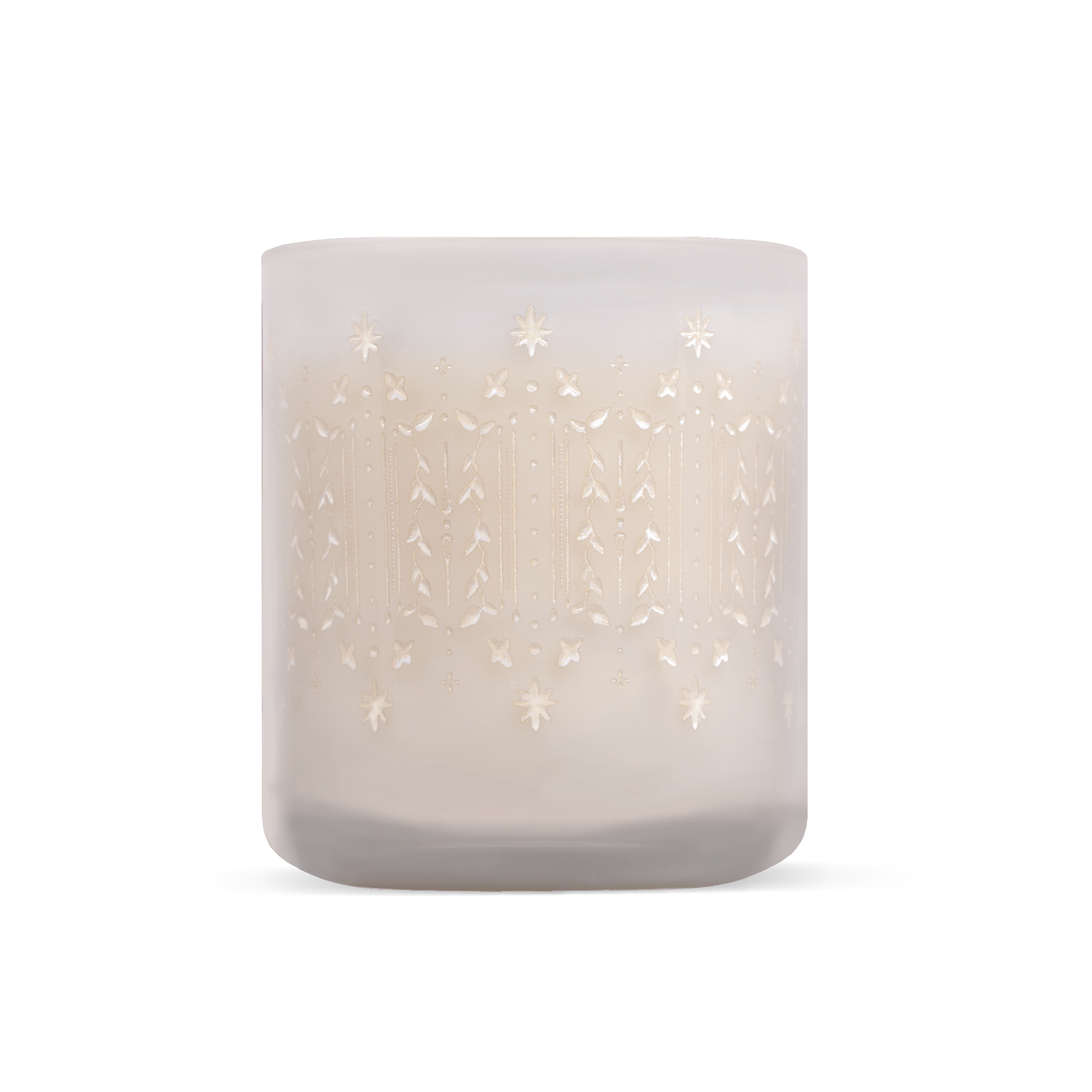 A frosted glass candle jar with a delicate, etched holiday pattern in a warm cream tone