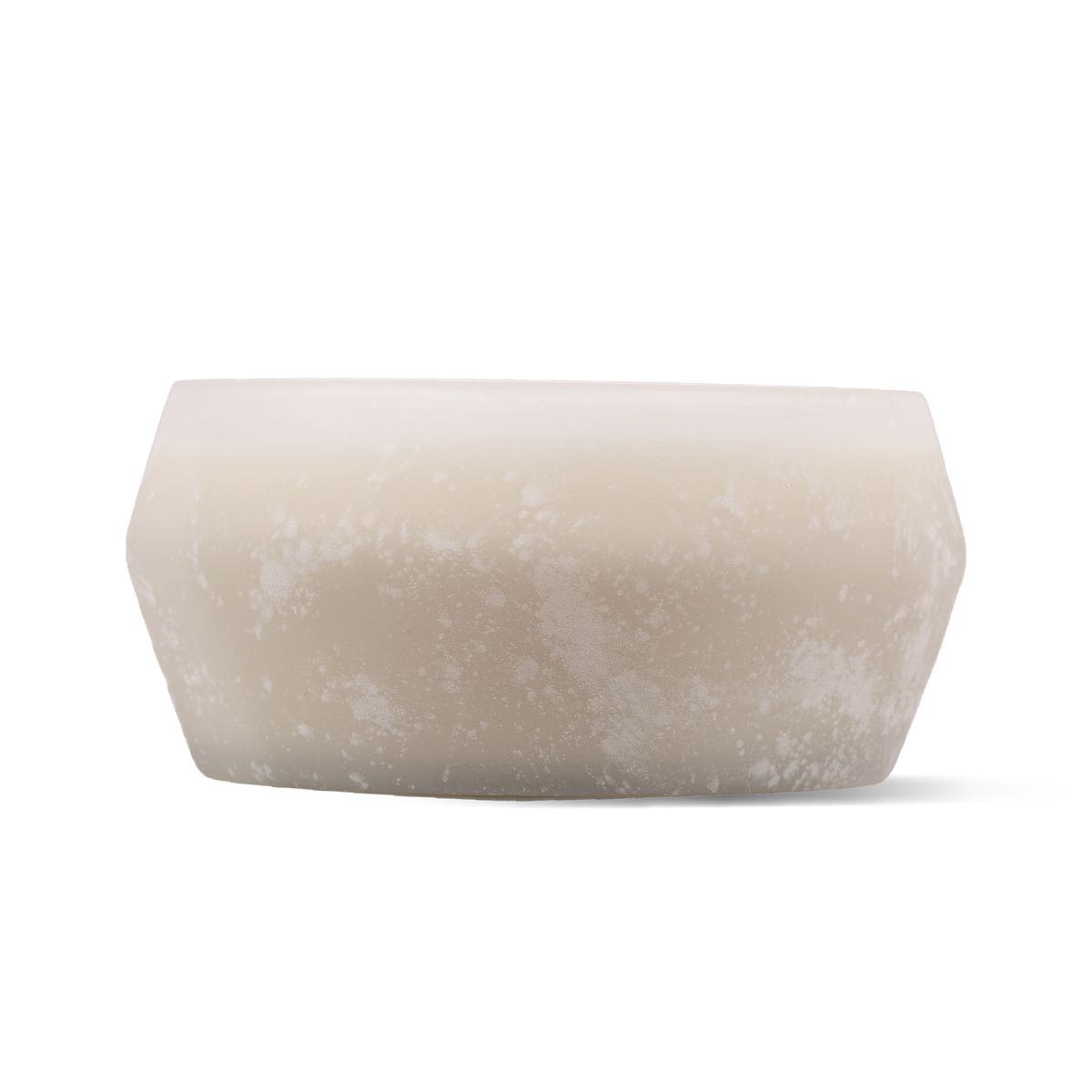 A frosted glass candle with a matte, textured finish in a warm cream-beige color