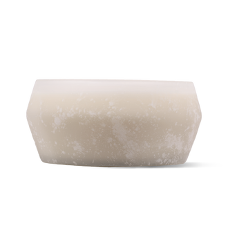 A frosted glass candle with a matte, textured finish in a warm cream-beige color