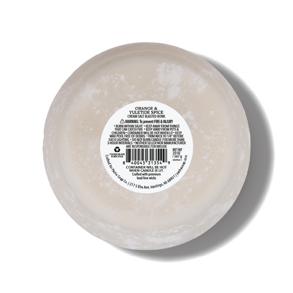 A round, white salt blasted candle bottom with a white label in the center reading 'ORANGE & YULETIDE SPICE'. The candle is photographed from a top-down angle