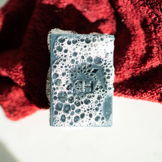 Tea Tree & Charcoal Bar Soap covered in bubbles